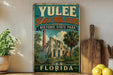 A vintage-style sign for Yulee Sugar Mill Ruins, a historic state park in Florida, with a tropical landscape and palm trees.