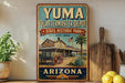 A vintage-style sign for Yuma Quartermaster Depot, a historic park in Arizona, featuring a wagon and a desert landscape.