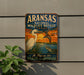 A vintage-style sign for the Arkansas National Wildlife Refuge in Texas, featuring an illustration of a bird and a turtle against a sunset backdrop.