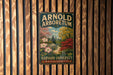 A vintage-style sign for the Arnold Arboretum, a Harvard University campus in Massachusetts, is displayed on a wooden wall.