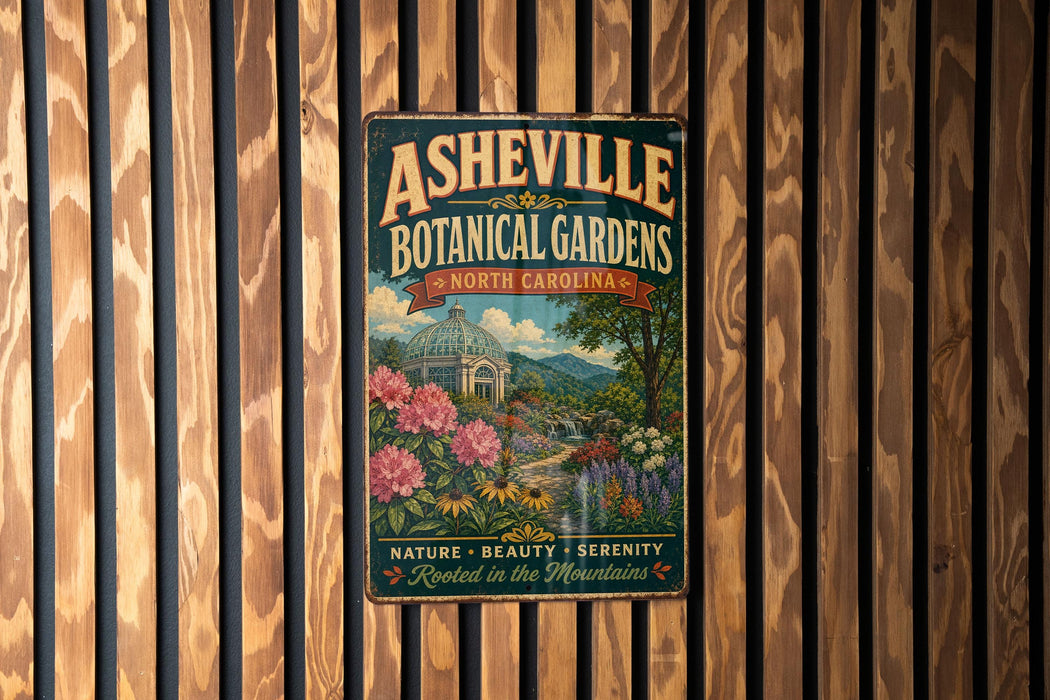 A vintage-style metal sign for the Asheville Botanical Gardens in North Carolina, featuring a scenic landscape with a greenhouse and flowers.