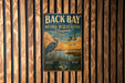 a vintage-style metal sign with a bird illustration, mounted on a wooden wall.