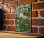 A vintage-style metal sign for Bartram's Garden in Pennsylvania, featuring a lush garden scene with flowers and trees.