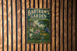 A vintage metal sign for Bartram's Garden in Pennsylvania, featuring a painting of a garden scene with flowers and a house.