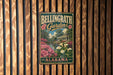 A vintage metal sign for Bellingham Gardens in Alabama, featuring a scenic illustration of a garden with flowers and a building.
