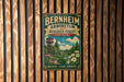 A vintage-style metal sign for the Bernheim Arboretum and Research Forest in Kentucky, featuring a scenic landscape with a tower and flowers.