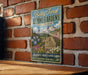 A vintage-style metal sign for Betty Ford Alpine Gardens in Colorado, featuring a mountain landscape with flowers and text indicating the location as the "America's Highest Alpine Garden".