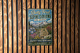 A vintage-style metal sign for Betty Ford Alpine Gardens in Colorado, featuring a mountain landscape and colorful flowers.