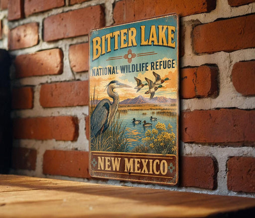 A vintage metal sign for the Bitter Lake National Wildlife Refuge in New Mexico, featuring an illustration of a heron and ducks in a lake.