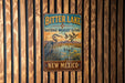 A vintage metal sign for the Bitter Lake National Wildlife Refuge in New Mexico, featuring an illustration of a heron and ducks in a lake.