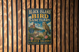 A vintage-style metal sign for the Block Island Bird Sanctuary in Rhode Island, featuring an illustration of an owl and a lighthouse.