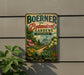 A vintage-style metal sign for Boerner Botanical Gardens in Wisconsin, featuring a lush garden scene with flowers, plants, and a greenhouse.