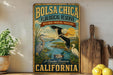 A vintage-style metal sign for the Bolsa Chica Ecological Reserve in California, featuring illustrations of various birds and wildlife in a natural setting.