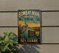 A vintage metal sign for the Bombay Hook National Wildlife Refuge in Delaware, featuring a large blue heron and a sunset landscape.