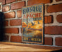 A vintage-style metal sign for Bosque del Apache National Wildlife Refuge in New Mexico, featuring an illustration of a crane and a sunset over a body of water.