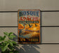 A vintage metal sign for Bosque del Apache National Wildlife Refuge in New Mexico, featuring an illustration of a crane and a sunset landscape.