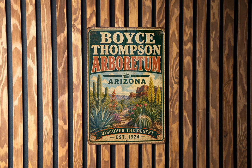 A vintage-style metal sign for the Boyce Thompson Arboretum in Arizona, featuring an illustration of desert plants and a desert landscape.