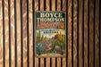 A vintage-style metal sign for the Boyce Thompson Arboretum in Arizona, featuring an illustration of desert plants and a desert landscape.