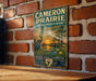 A vintage-style metal sign for the Cameron Prairie National Wildlife Refuge in Louisiana, featuring a serene landscape with a heron and palm trees.