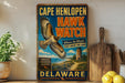 A vintage-style sign for Cape Henlopen Hawk Watch, featuring an illustration of a hawk in flight and a lighthouse in the background, with the text "Cape Henlopen Hawk Watch Witness the Wonder Soar above the Cape Delaware" and "Education Conservation Research" below.