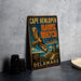 A vintage metal sign for Cape Henlopen Hawk Watch, featuring an illustration of a hawk in flight and text promoting the bird-watching experience in Delaware.