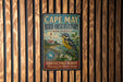 A vintage-style metal sign for Cape May Bird Observatory in New Jersey, featuring a bird illustration and text promoting birdwatching and natural heritage preservation.