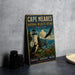 A vintage-style metal sign for the Cape Meares National Wildlife Refuge in Oregon, featuring a lighthouse, puffins, and an eagle, is displayed on a gray concrete surface.