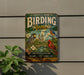A vintage-style metal sign for Central Park's Birding Ramey, featuring illustrations of birds and a scenic background.