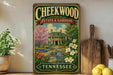 A vintage-style sign for Cheekwood Estate & Gardens in Tennessee, featuring a colorful illustration of a house surrounded by flowers and a garden.