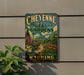 A vintage-style metal sign for Cheyenne Botanic Gardens in Wyoming, featuring a colorful illustration of a greenhouse surrounded by flowers and plants.