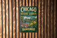 A vintage-style metal sign for the Chicago Botanic Garden in Illinois, featuring a scenic illustration of the garden and its surroundings.