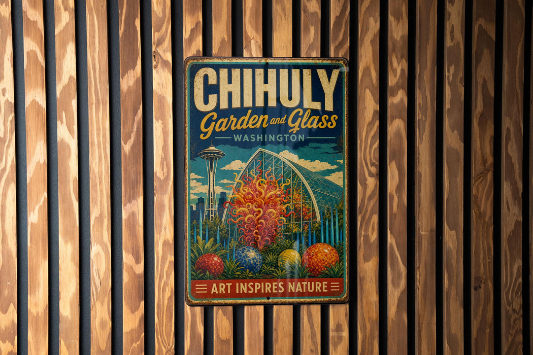 A vintage metal sign with the text "CHIHULY Garden & Glass WASHINGTON" and an illustration of a greenhouse, hanging on a wooden wall.