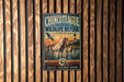 A vintage-style metal sign for the Chincoeteague National Wildlife Refuge in Virginia, featuring an illustration of horses and a lighthouse.