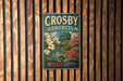 A vintage metal sign for Crosby Arboretum in Mississippi, featuring a scenic landscape with trees, flowers, and a river.