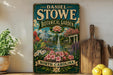 A vintage-style sign for Daniel Stowe Botanical Garden in North Carolina, featuring a garden scene with a fountain and flowers.