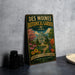 A vintage-style metal sign for the Des Moines Botanical Garden in Iowa, featuring a colorful illustration of the garden and a prominent dome structure.
