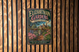 A vintage-style metal sign for Elizabethan Gardens in North Carolina, featuring a garden scene with a path leading through the flowers.