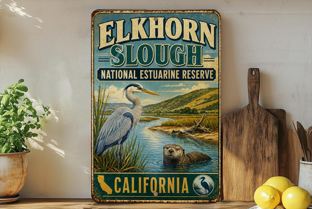 A vintage-style metal sign for Elkhorn Slough National Estuarine Reserve in California, featuring an illustration of a heron and an otter in a body of water.