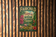 A vintage-style metal sign for the Fairchild Tropical Botanic Garden in Florida, featuring colorful illustrations of tropical plants and flowers.