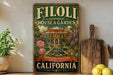 a vintage-style sign for Filoli Historic House & Garden in California, with a garden scene and a fountain.