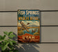 A vintage-style sign for the Fish Springs National Wildlife Refuge in Utah, featuring a bird in flight and a serene landscape.