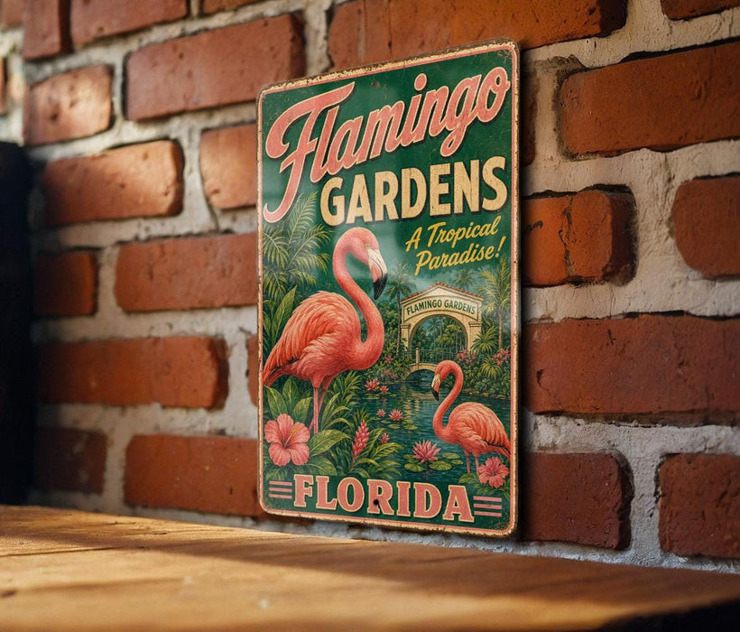 A vintage-style metal sign for Flamingo Gardens in Florida, featuring a pink flamingo and tropical foliage.