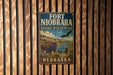 A vintage-style metal sign for Fort Niobrara National Wildlife Refuge in Nebraska, featuring an illustration of a buffalo and an eagle.