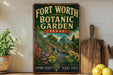 A vintage-style sign for the Fort Worth Botanic Garden in Texas, featuring a lush garden scene with a waterfall and various plants.