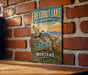 A vintage metal sign for Freezout Lake, the wildlife management area in Montana, featuring a scenic illustration of a bird in flight and a deer in the background.