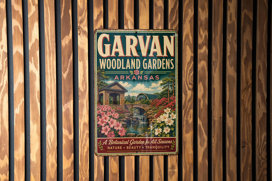 A vintage-style metal sign for the Garvan Woodland Gardens in Arkansas, featuring a scenic landscape with a bridge, flowers, and a waterfall.