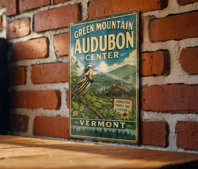 A vintage-style sign for the Green Mountain Audubon Center in Vermont, featuring a bird illustration and text promoting the center's mission to connect people and nature.