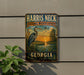 A vintage metal sign for the National Wildlife Refuge in Georgia, featuring a large blue heron and a sunset landscape.