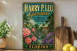 A vintage-style metal sign for "Harry P. Leu Gardens" in Florida, featuring a tropical garden scene with palm trees, flowers, and a bridge.
