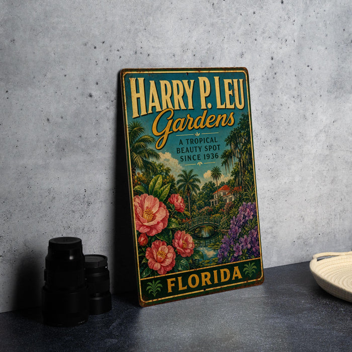 A vintage-style metal sign for Harry P. Leu Gardens, featuring a tropical garden scene with palm trees, flowers, and a house.